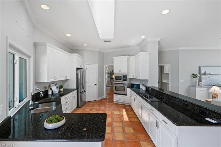 Gourmet kitchen featuring expansive countertops and clean, contemporary design