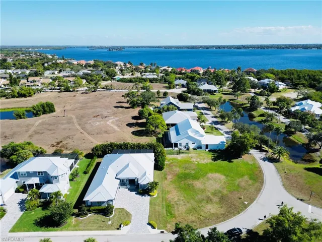 Aerial perspective of suburban area with a nearby body of water