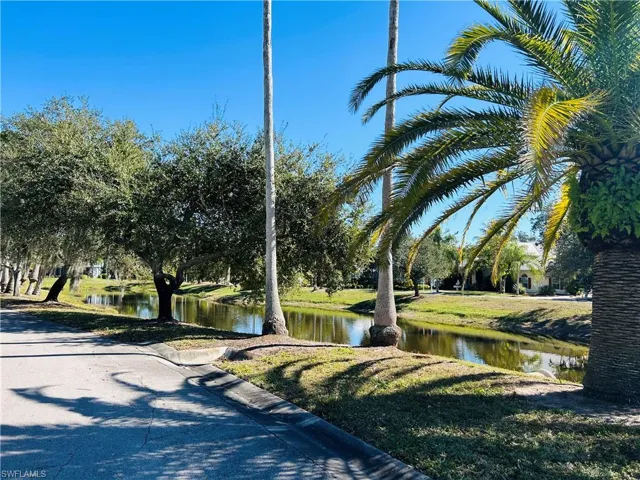 View of community with a water view and a yard