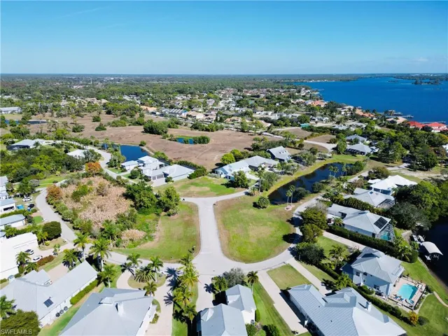 Aerial perspective of suburban area featuring a large body of water