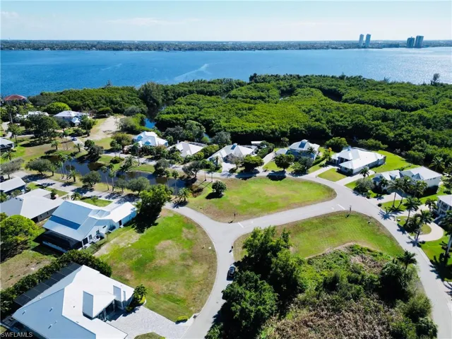 Aerial perspective of suburban area with a large body of water