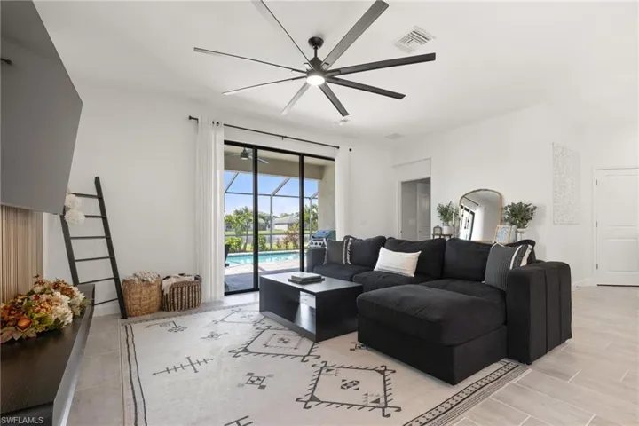 Living room with light hardwood / wood-style flooring and ceiling fan