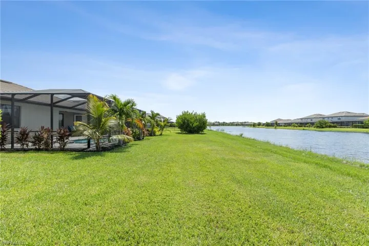 View of yard featuring a lanai and a water view