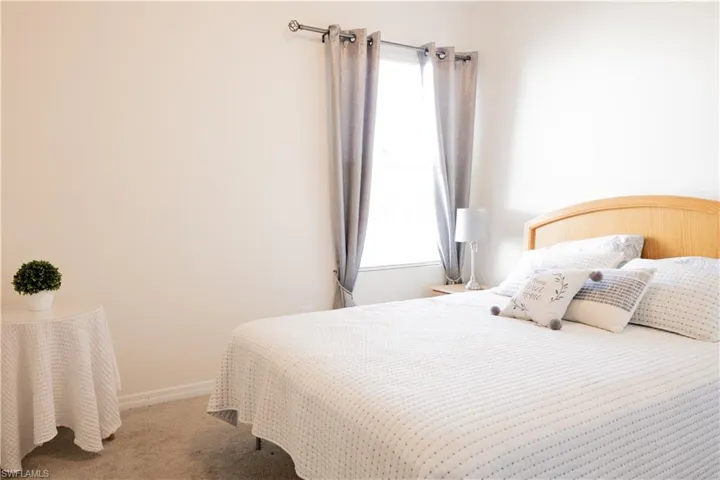 Carpeted bedroom featuring baseboards