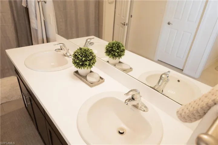 Full bathroom featuring double vanity and a sink