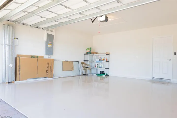 Garage with a garage door opener and electric panel