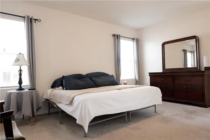 Bedroom featuring light colored carpet