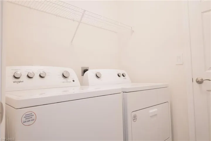 Laundry room with laundry area and washer and clothes dryer