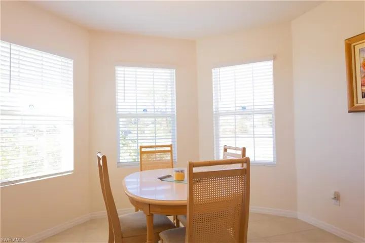 Dining area with light tile patterned floors and baseboards