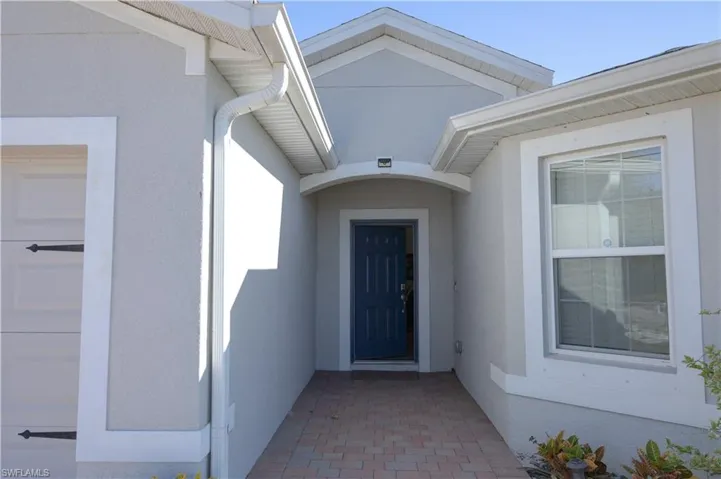 Doorway to property with stucco siding