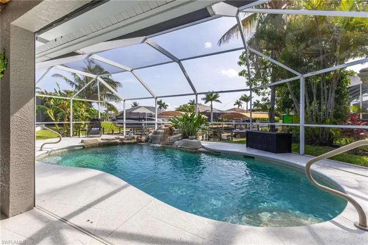 Outdoor pool featuring a patio and glass enclosure