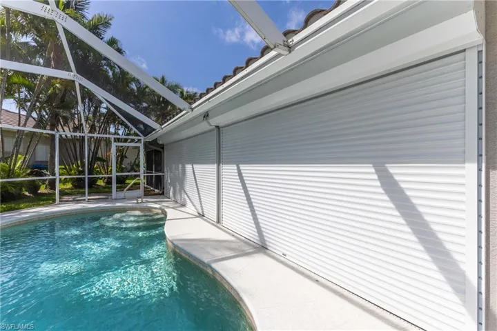 Swimming pool with glass enclosure