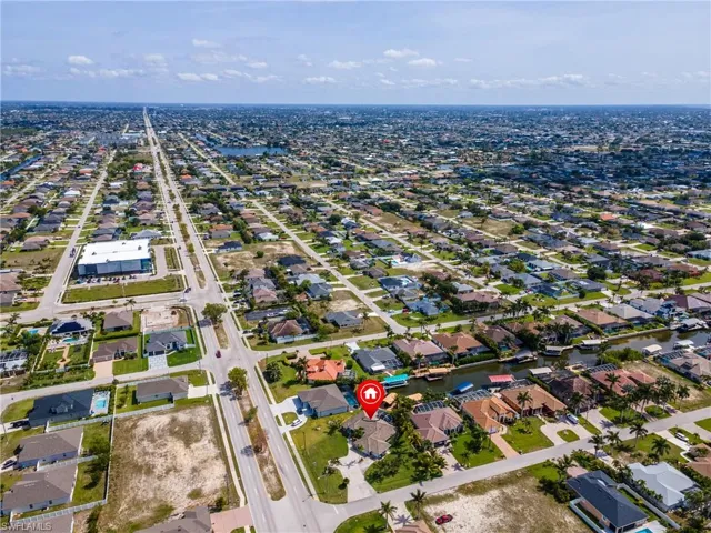 Aerial view of property's location with nearby suburban area