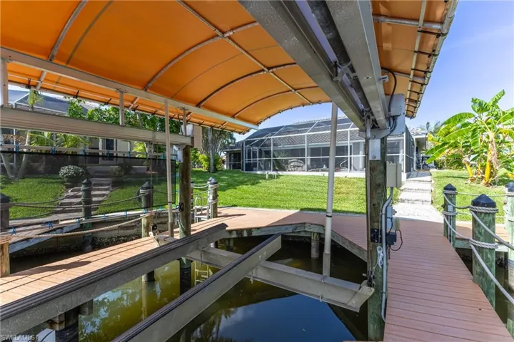 Dock with boat lift and a yard