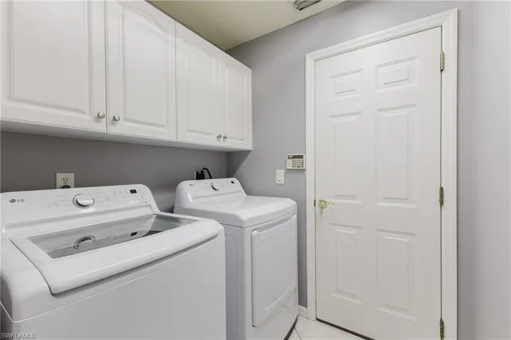Laundry area with washer and clothes dryer and cabinet space