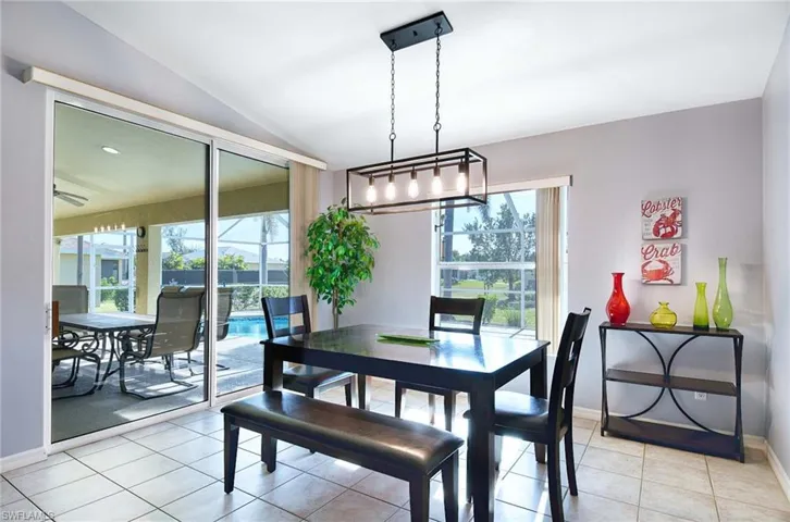 Tiled dining space with lofted ceiling