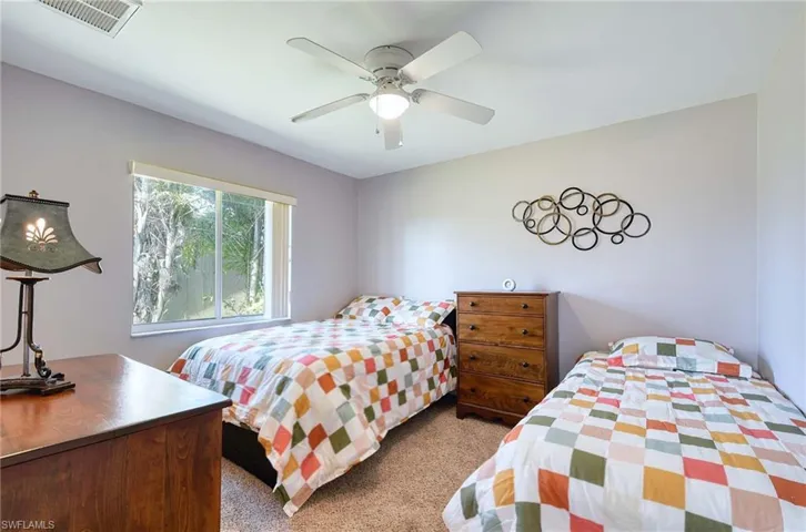 Carpeted bedroom #3 featuring ceiling fan, Double bed + Single bed
