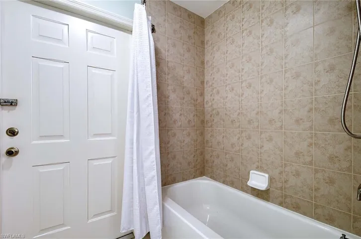 Bathroom with shower / tub combo with curtain