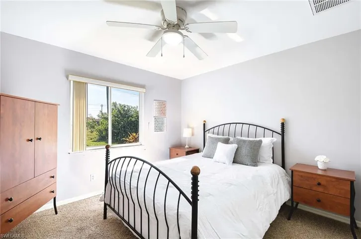 Bedroom #2 featuring carpet flooring, a closet, ceiling fan and queen bed