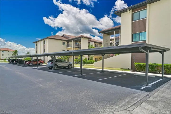 Covered parking area featuring multiple carport structures with metal roofing