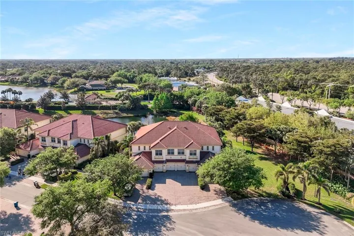 Birds eye view of property with a water view