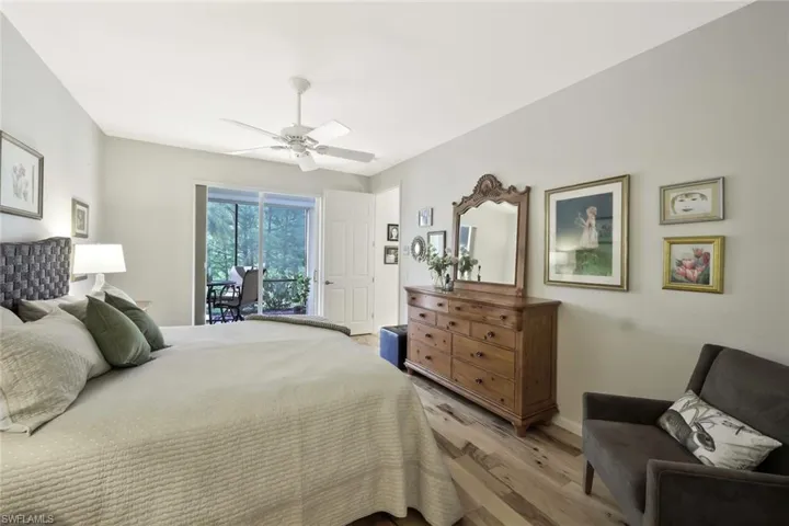 Bedroom with a ceiling fan, access to exterior, and light wood-type flooring