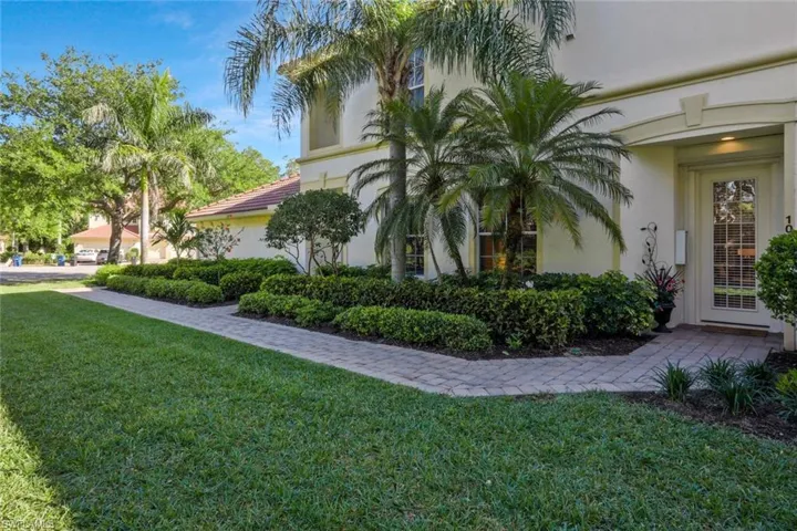 View of home's exterior with a lawn and stucco siding
