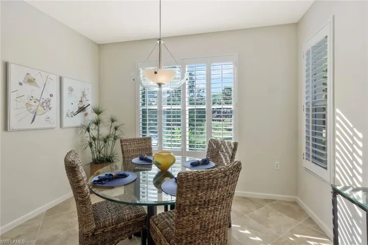 Dining space with light tile patterned flooring and baseboards