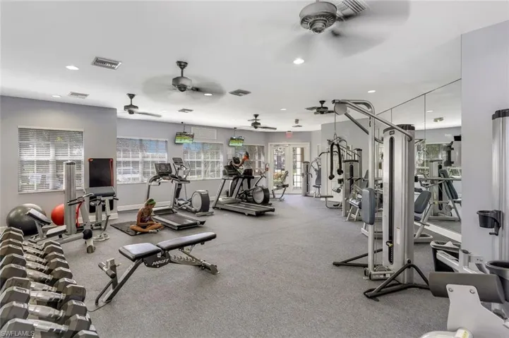 Workout area featuring recessed lighting, baseboards, visible vents, and ceiling fan