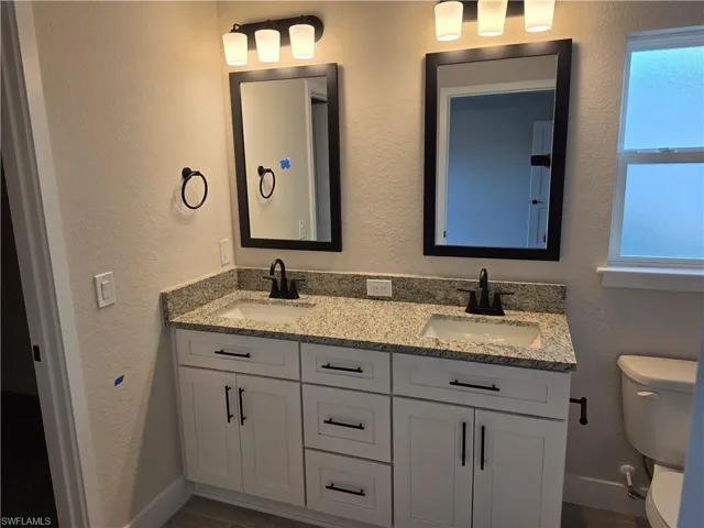 Dual vanity with light-toned countertop and integrated sinks