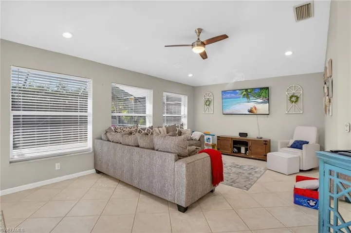 Living room featuring ceiling fan, light tile patterned floors, healthy amount of natural light, and recessed lighting