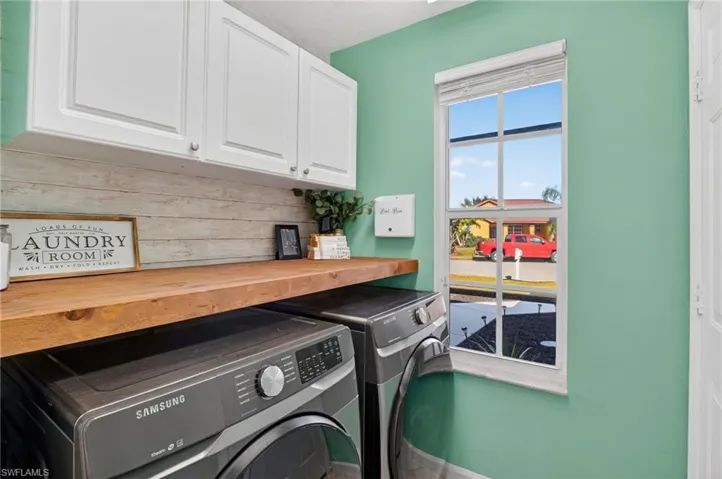 Laundry area featuring cabinet space and washer and dryer