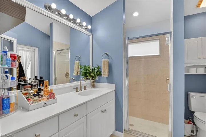 Full bath with a stall shower and vanity
