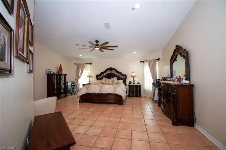 Bedroom with a ceiling fan, visible vents, recessed lighting, and light tile patterned floors