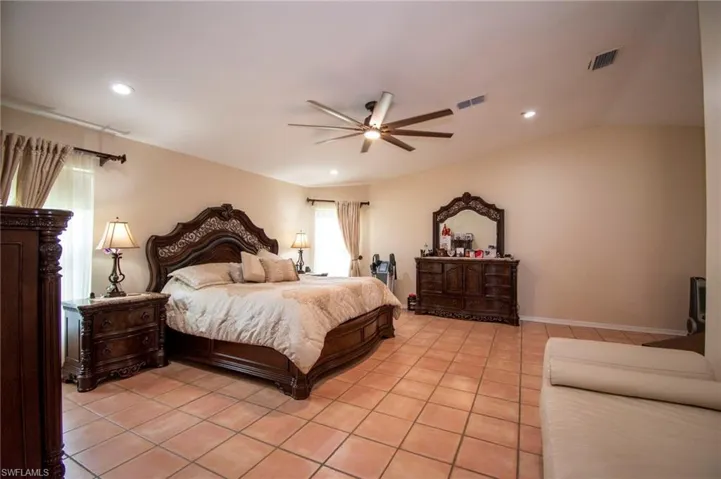 Bedroom with ceiling fan, visible vents, recessed lighting, and light tile patterned floors