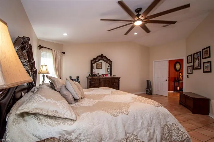 Bedroom featuring baseboards, recessed lighting, and light tile patterned flooring