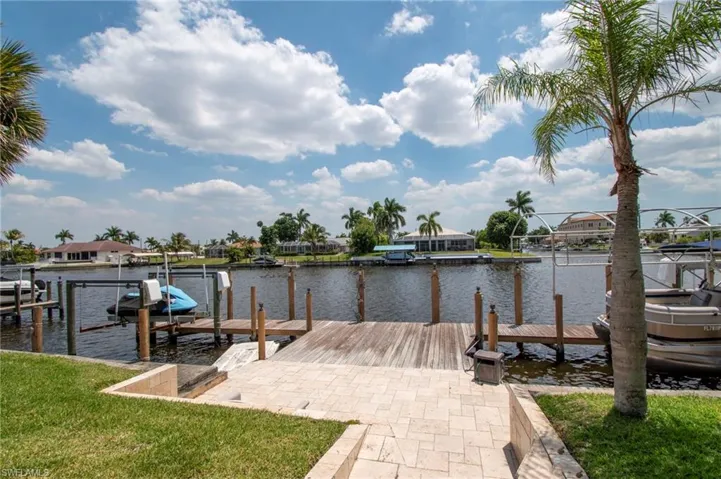 Dock area with a yard, a water view, and boat lift