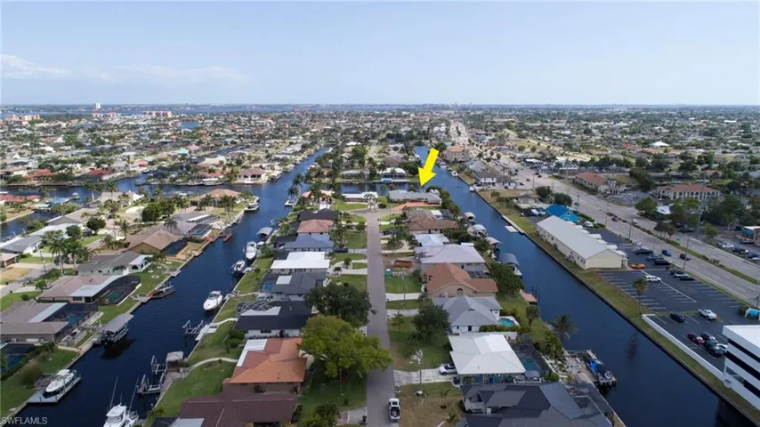 Drone / aerial view with a water view and a residential view