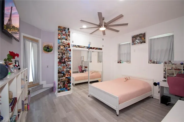 Bedroom featuring ceiling fan, baseboards, and light wood-type flooring