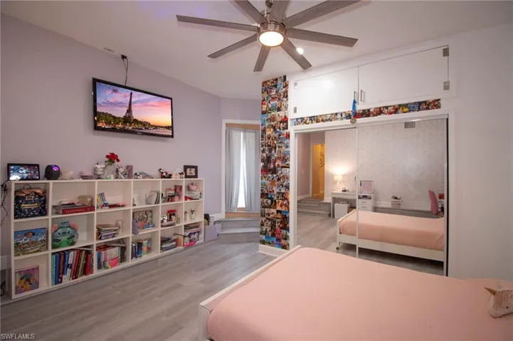 Bedroom featuring ceiling fan, wood finished floors, and a closet