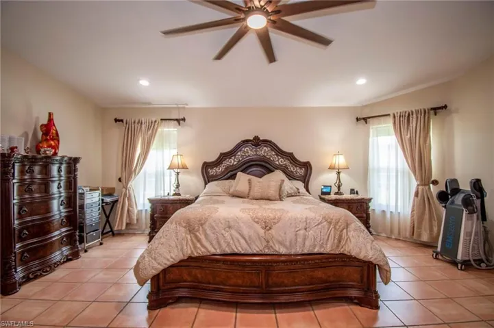Bedroom featuring recessed lighting, ceiling fan, and light tile patterned floors