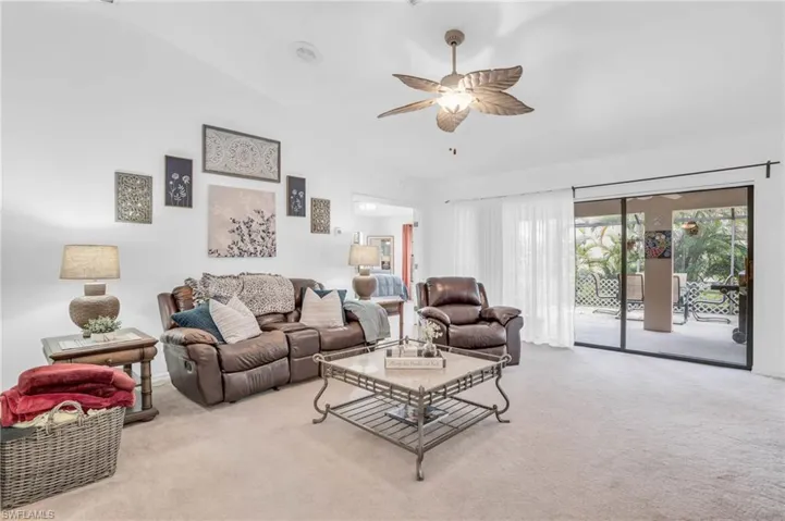 Living room with carpet and a large slider open to the extended lanai