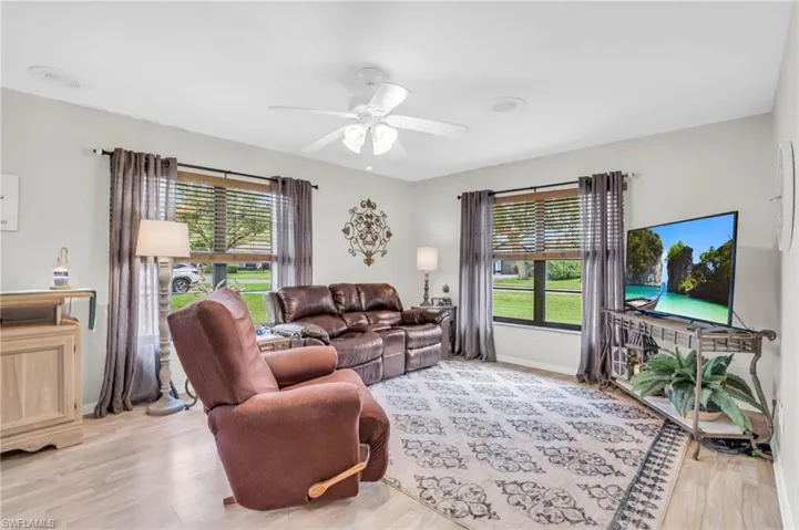 Family room with ceiling fan and lots of natural light