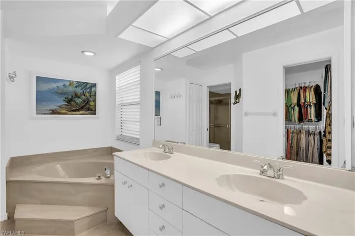 Master Bathroom w/ double vanity, soaker tub, separate walk-in shower pocket door for toilet