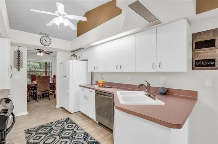 Kitchen featuring architectural flair and vaulted ceiling