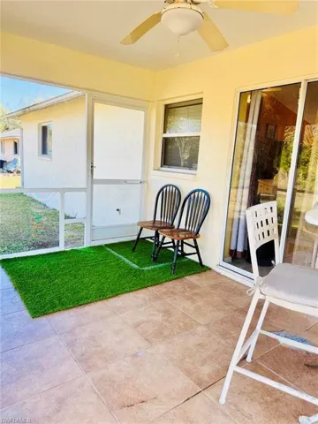 View of patio featuring ceiling fan and a sunroom