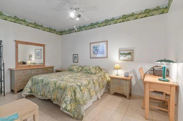Bedroom with light tile patterned flooring and ceiling fan