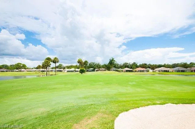 Surrounding community featuring a water view, a yard, a residential view, and golf course view