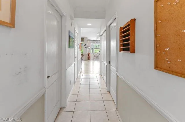 Corridor featuring light tile patterned floors