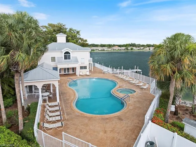 Community pool featuring a community hot tub, alongside the large lake.